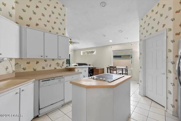 a kitchen with sink a microwave and cabinets