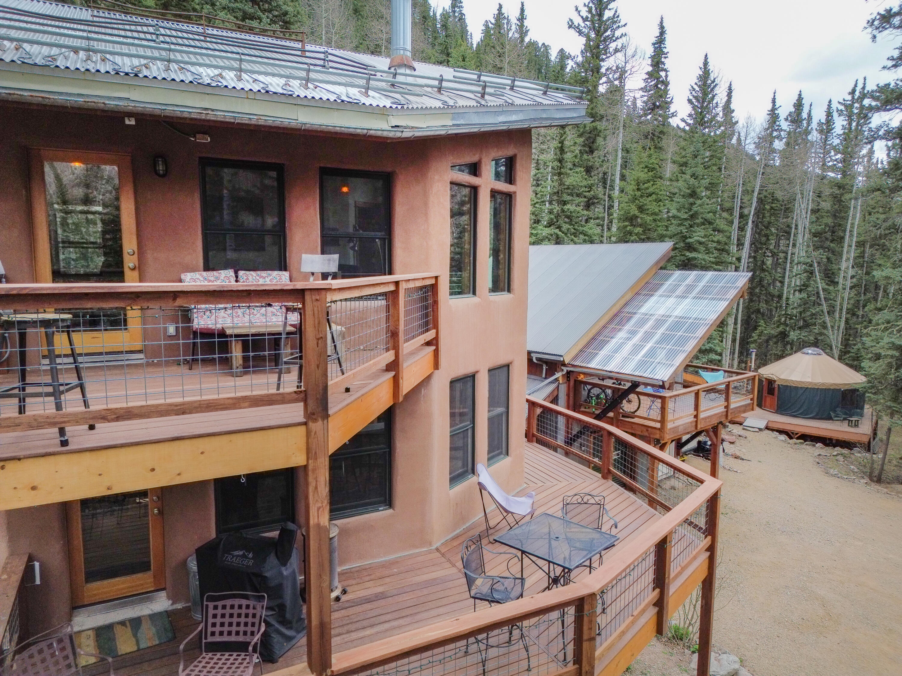 15322 Road 55.9 Rico, CO 81332 - Photo 12 of 32 a view of a patio with table and chairs with wooden floor and fence
