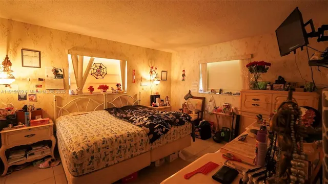 a bed room with two beds and a television