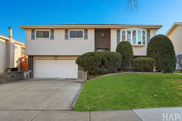 a front view of brick house with a yard
