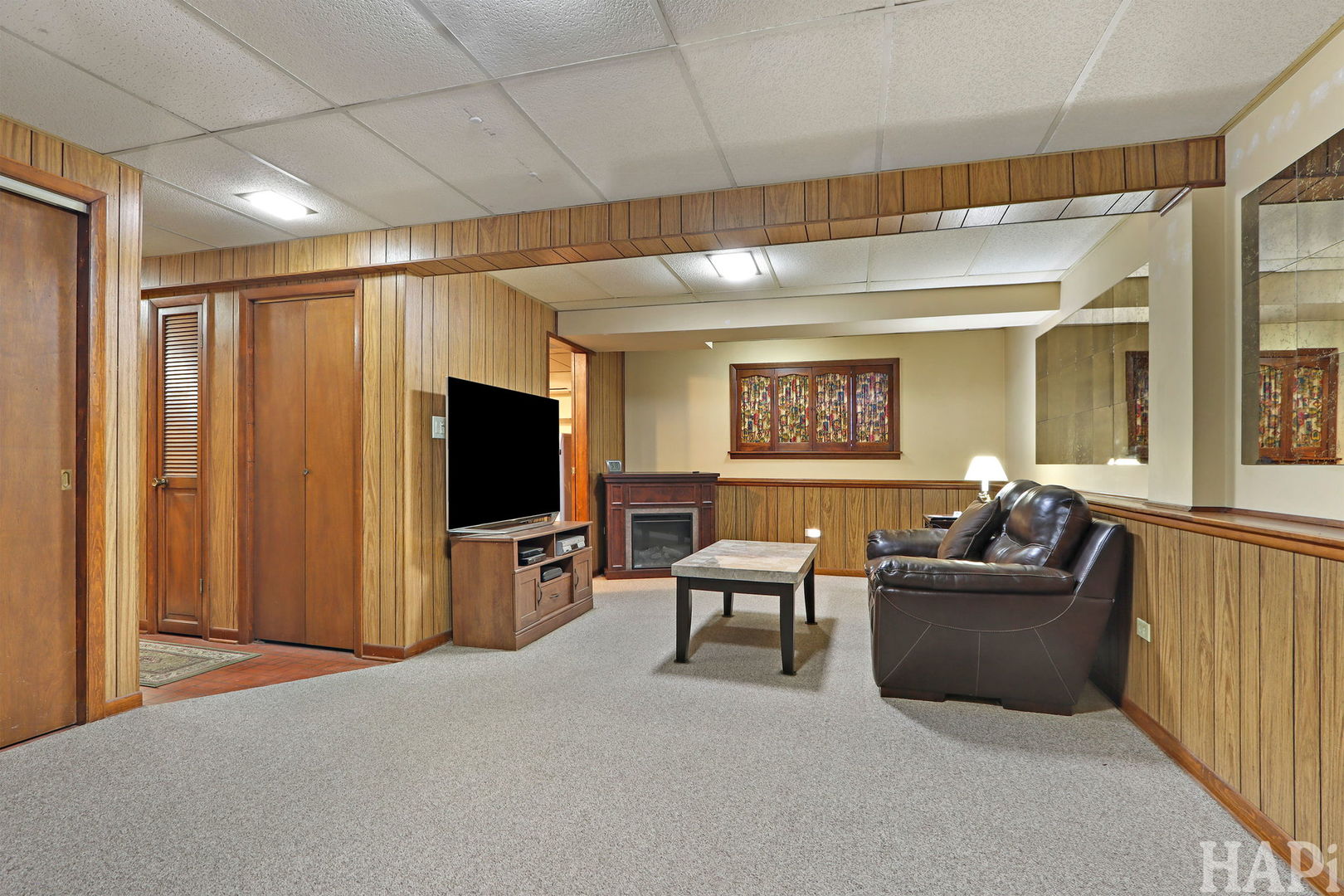 411 West Diversey Avenue Addison, IL 60101 - Photo 16 of 23 a living room with furniture and a flat screen tv