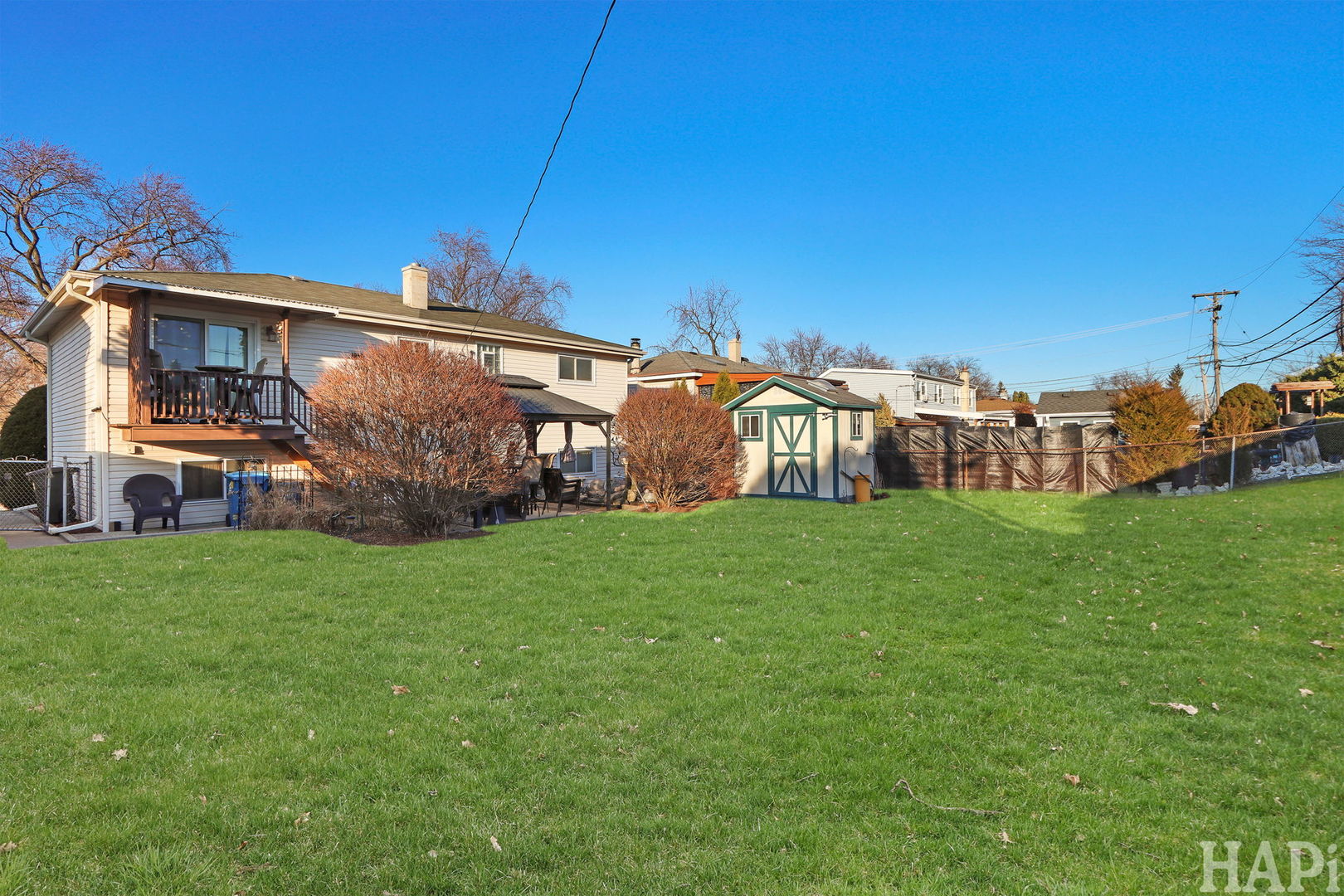 411 West Diversey Avenue Addison, IL 60101 - Photo 22 of 23 a view of a house with backyard and a tree