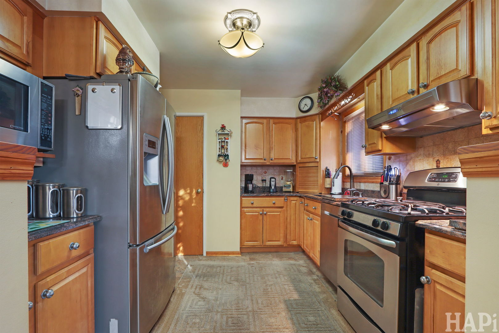 411 West Diversey Avenue Addison, IL 60101 - Photo 4 of 23 a kitchen with stainless steel appliances granite countertop a stove a refrigerator and a refrigerator