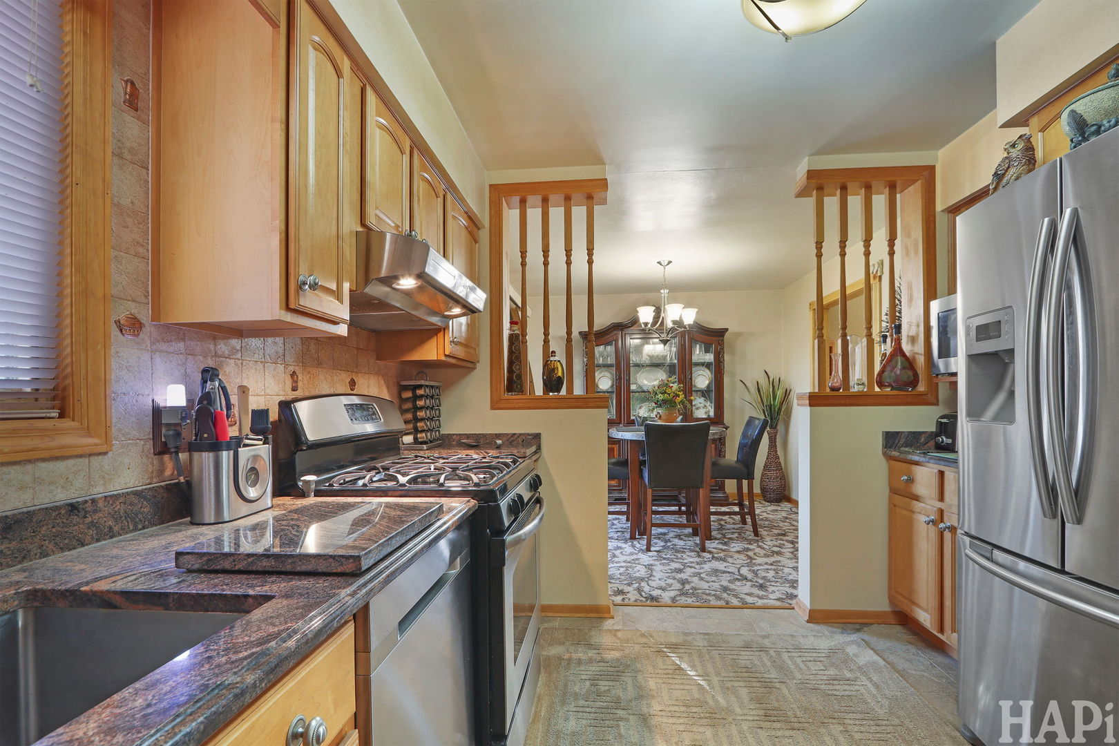411 West Diversey Avenue Addison, IL 60101 - Photo 5 of 23 a kitchen with stainless steel appliances granite countertop a refrigerator a stove and a sink
