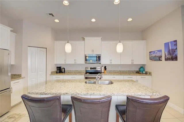 a kitchen with a dining table and chairs