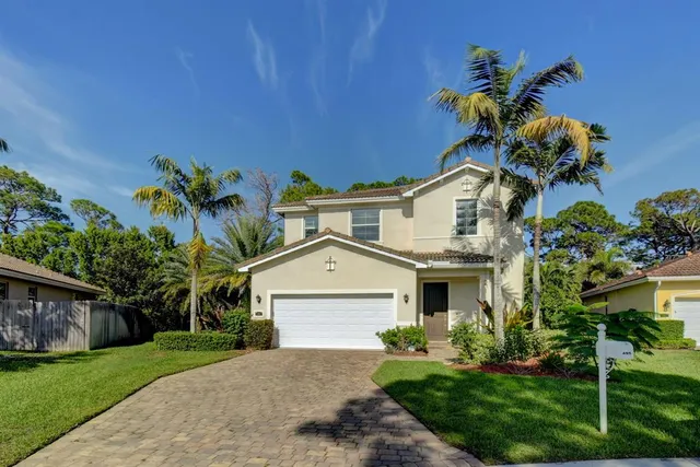 a front view of a house with a garden and a yard