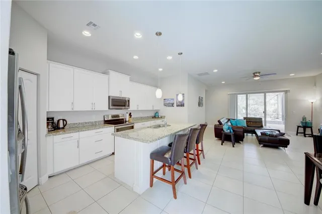 a kitchen with stainless steel appliances granite countertop a refrigerator and a sink