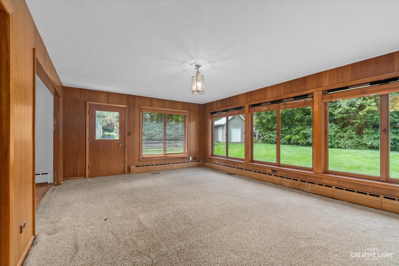 1402 Meadows Road Geneva, IL 60134 - Photo 12 of 30 a view of an empty room with a window and hardwood floor