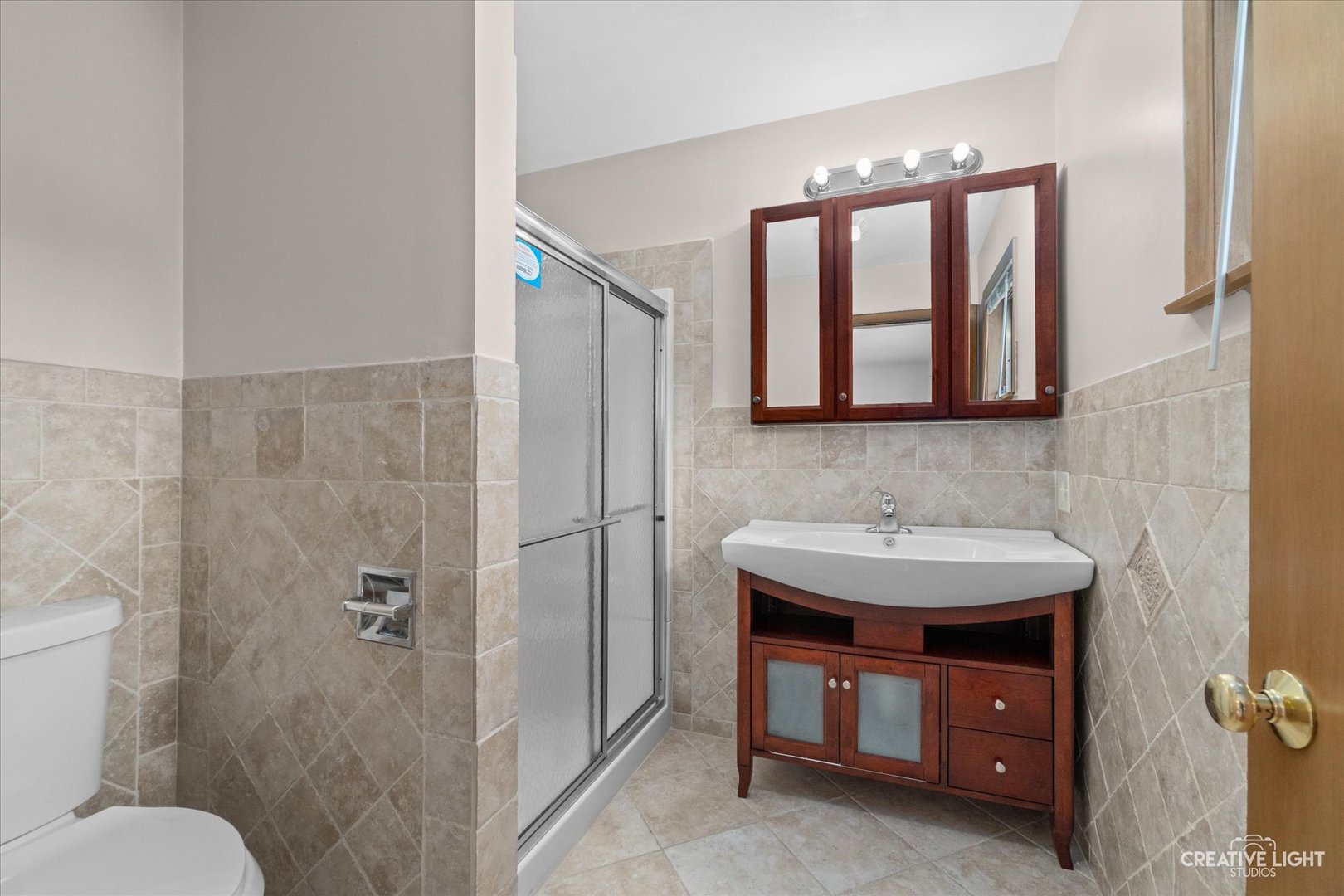 1402 Meadows Road Geneva, IL 60134 - Photo 17 of 30 a bathroom with a sink and a mirror