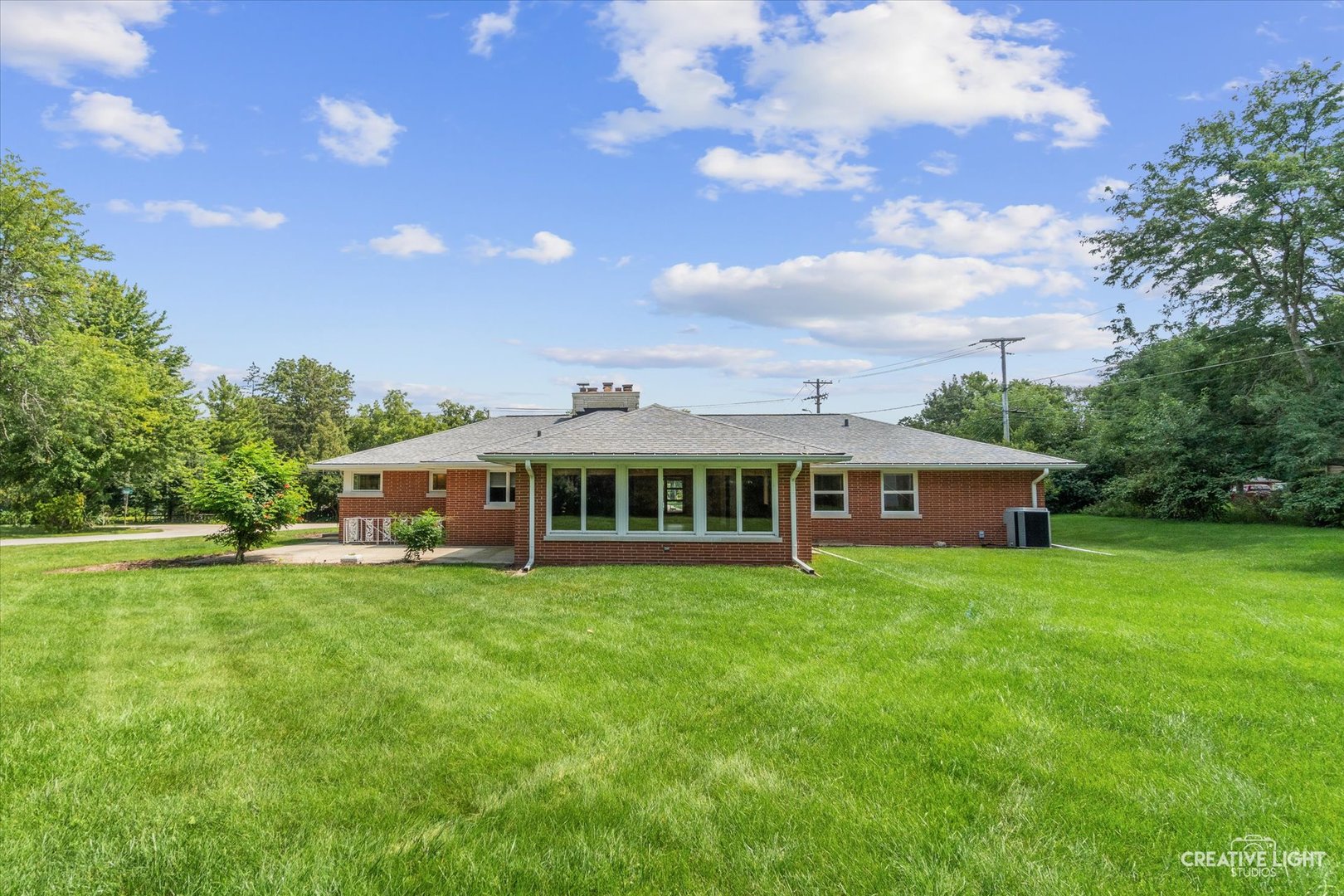 1402 Meadows Road Geneva, IL 60134 - Photo 27 of 30 a view of a house with a big yard and large trees