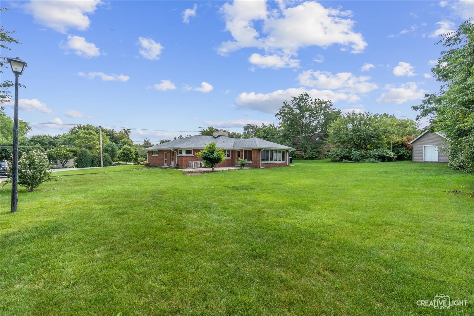 1402 Meadows Road Geneva, IL 60134 - Photo 29 of 30 a view of a house with a big yard and large trees