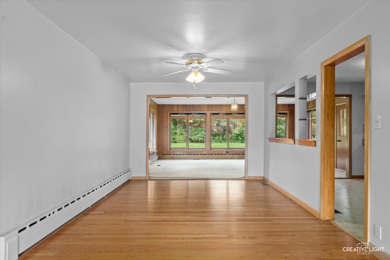 1402 Meadows Road Geneva, IL 60134 - Photo 7 of 30 a view of an empty room with window and wooden floor