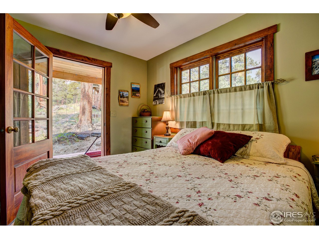 2112 Eagle Cliff Road Estes Park, CO 80517 - Photo 15 of 30 a bedroom with a large bed and a large window