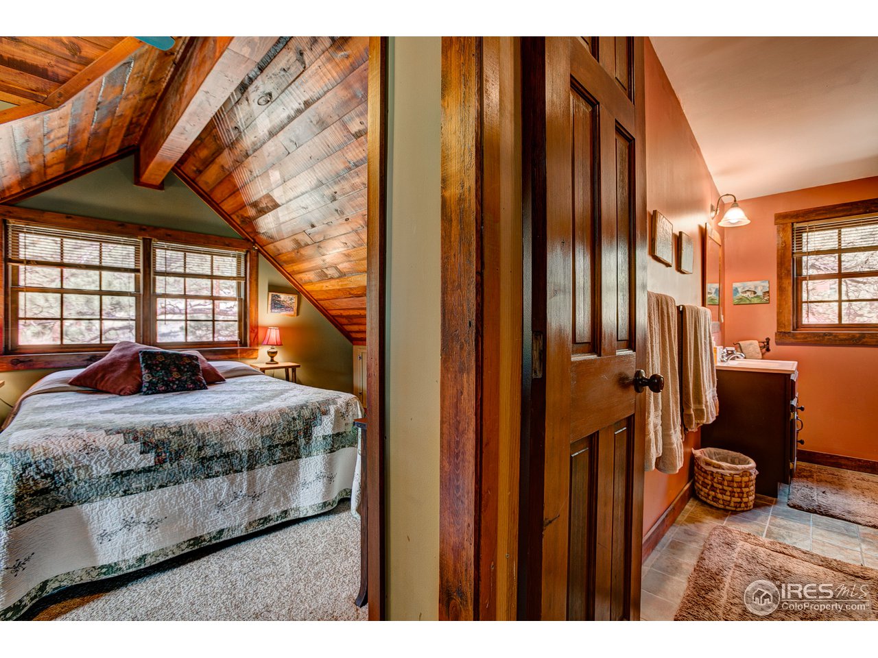 2112 Eagle Cliff Road Estes Park, CO 80517 - Photo 22 of 30 a bedroom with a bed and wooden floor