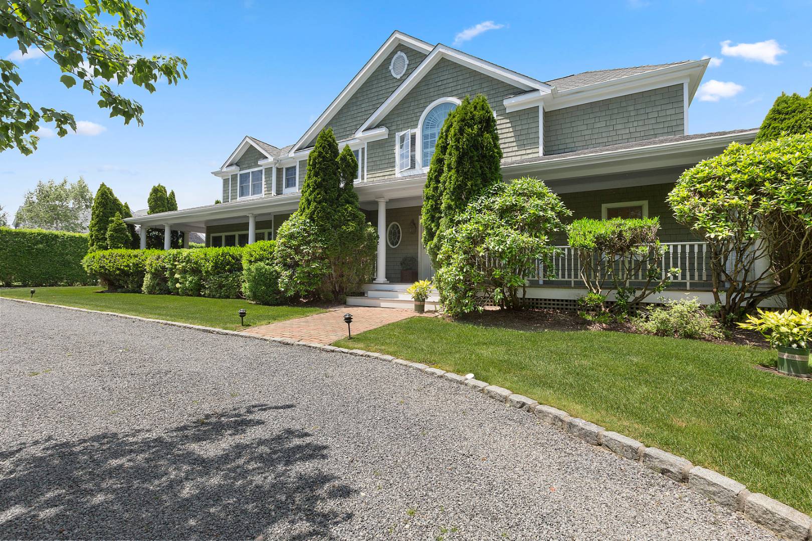 109 Mill Creek Close Water Mill, NY 11976 - Photo 1 of 15 a front view of house with yard and green space