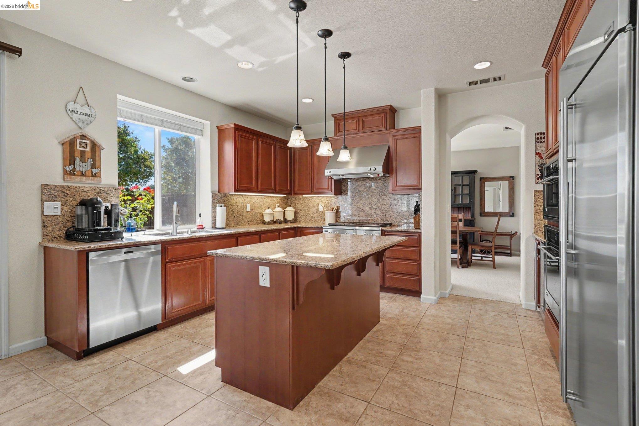 106 Little Ranch Circle Oakley, CA 94561 - Photo 14 of 34 Kitchen featuring a central island with granite countertop, wood cabinetry, stainless steel appliances, and recessed lighting