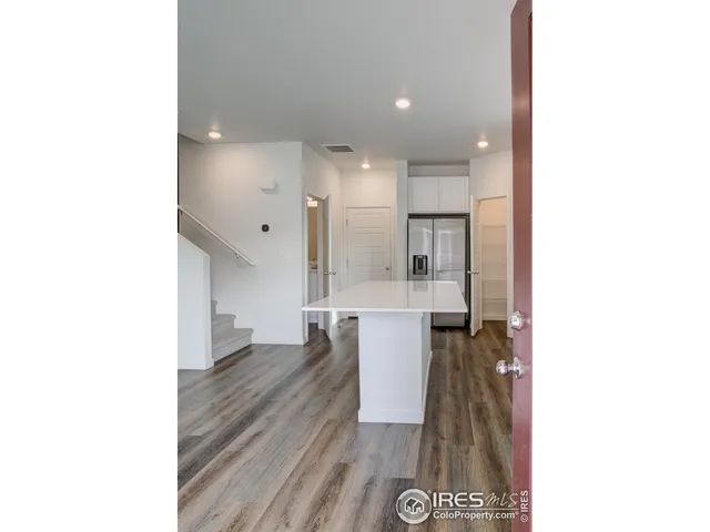 a kitchen with granite countertop a stove top oven and cabinets