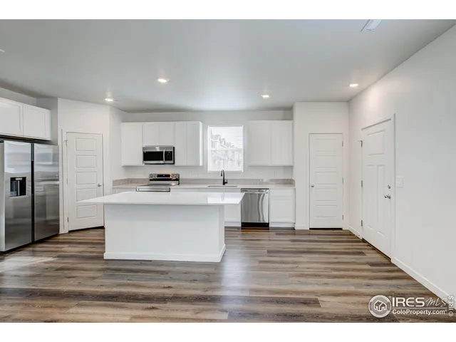 a kitchen with stainless steel appliances a stove a sink and a microwave