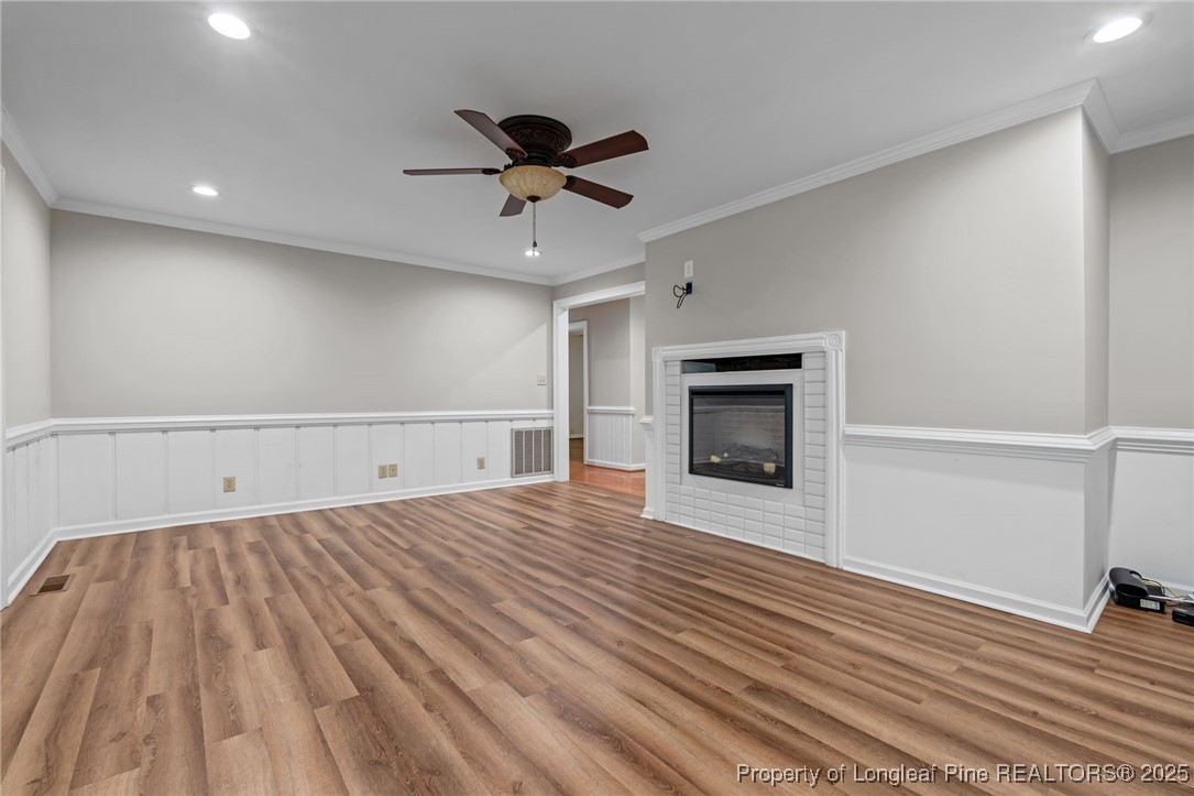 610 Maynard Lake Road Erwin, NC 28339 - Photo 25 of 49 a view of empty room with wooden floor and fireplace