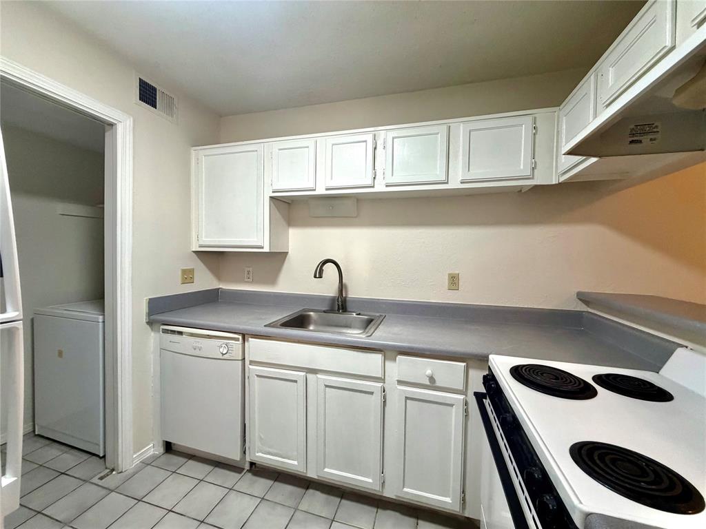 18333 Roehampton Drive, Unit 624 Dallas, TX 75252 - Photo 20 of 39 a kitchen with white cabinets appliances and sink