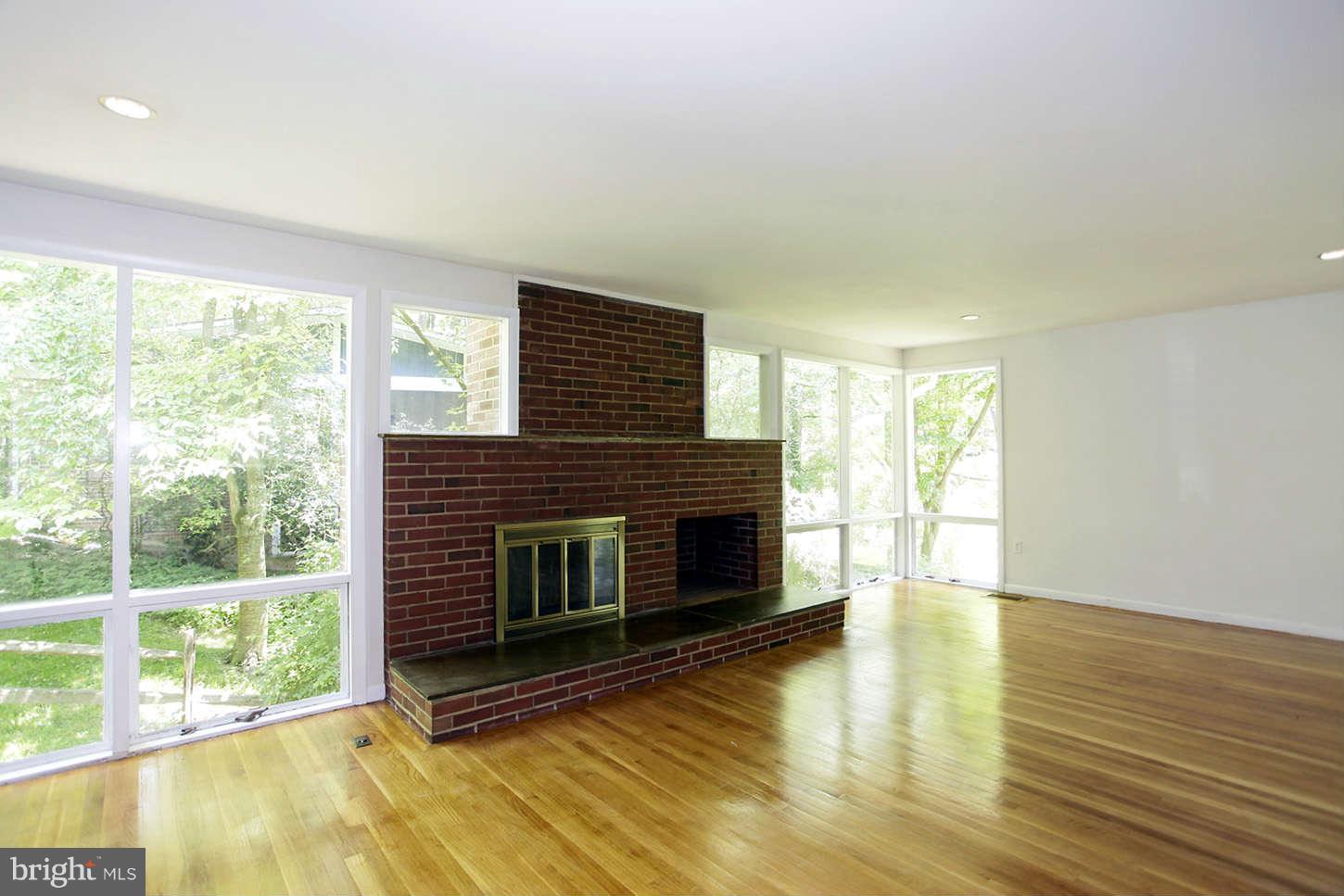 3912 Rickover Road Silver Spring, MD 20902 - Photo 14 of 30 wooden floor fireplace and windows in an empty room