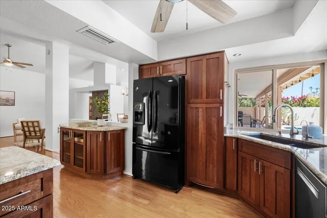 a kitchen with stainless steel appliances granite countertop a refrigerator stove and sink