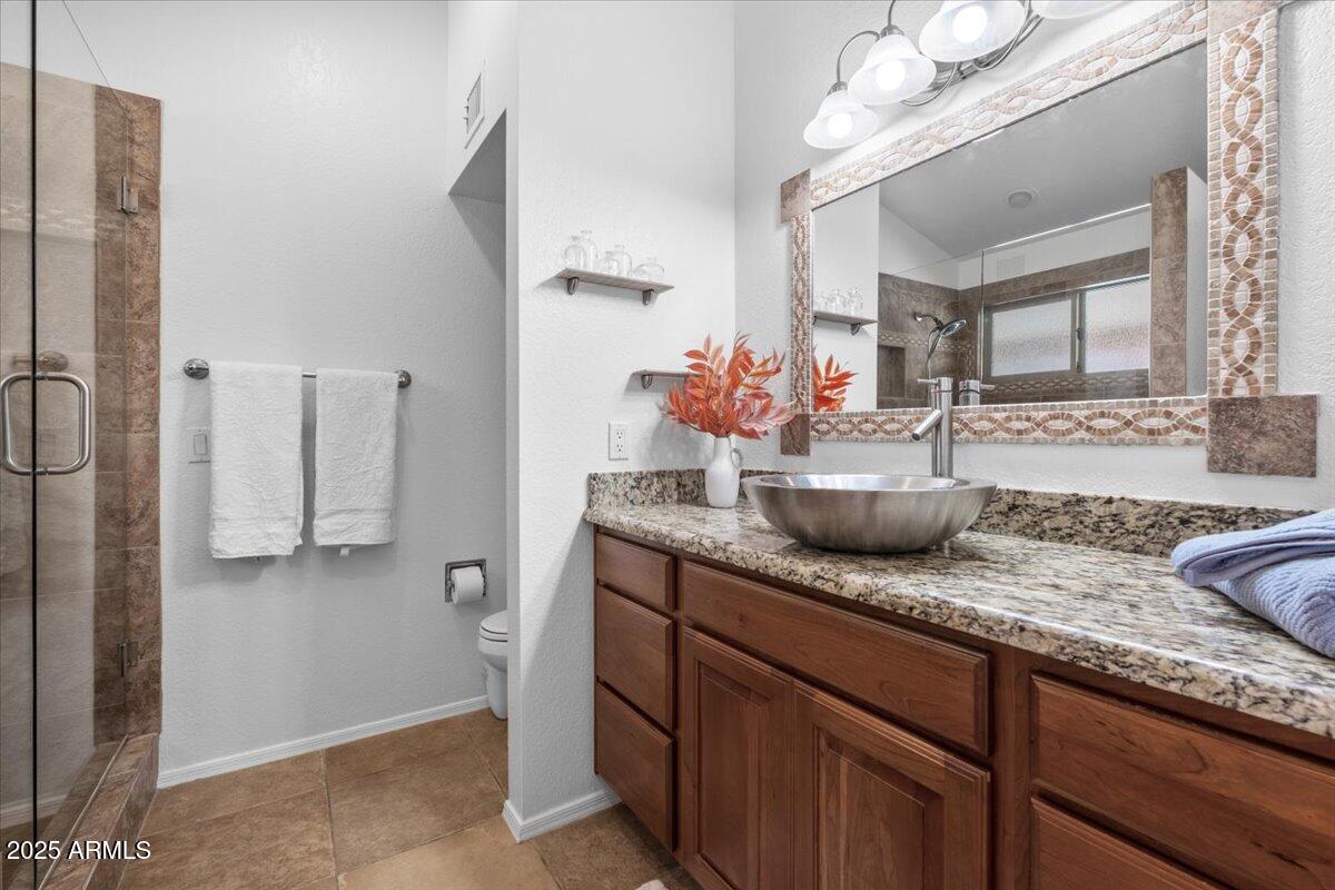 9081 East Sahuaro Drive Scottsdale, AZ 85260 - Photo 16 of 22 a bathroom with sink and mirror