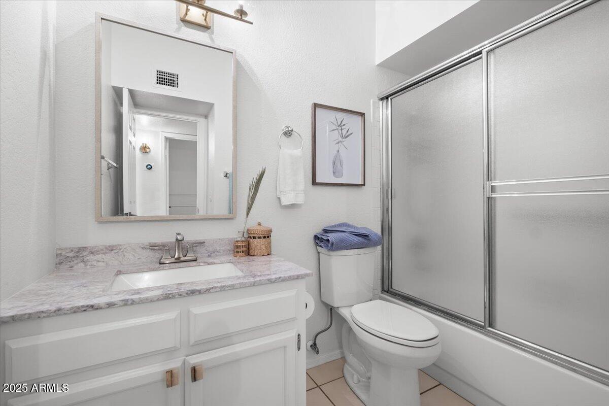 9081 East Sahuaro Drive Scottsdale, AZ 85260 - Photo 20 of 22 a bathroom with a toilet a sink and a mirror