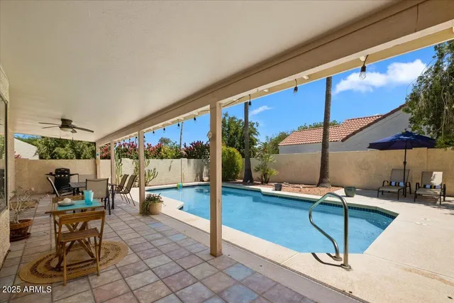 a view of a backyard with plants and patio
