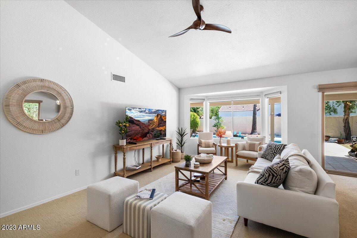 9081 East Sahuaro Drive Scottsdale, AZ 85260 - Photo 4 of 22 a living room with furniture and a flat screen tv