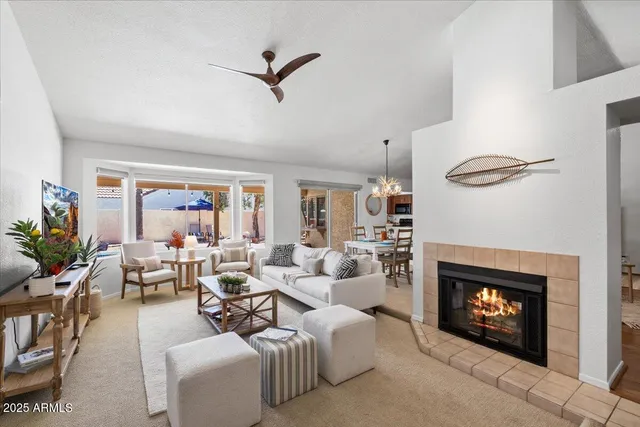 a living room with furniture a fireplace and a flat screen tv