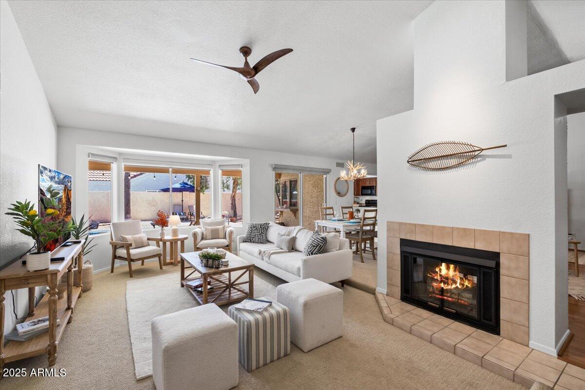 9081 East Sahuaro Drive Scottsdale, AZ 85260 - Photo 6 of 22 a living room with furniture a fireplace and a flat screen tv