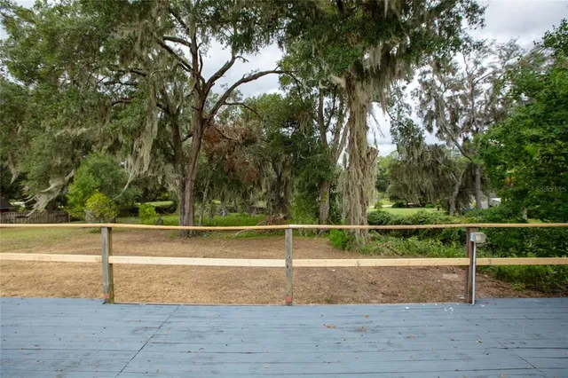 an aerial view of residential houses with outdoor space and ocean