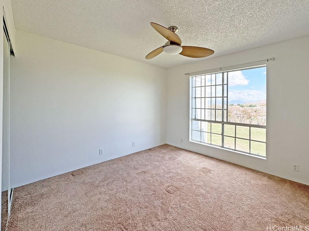 92-1150 Hame Street, Unit 8102 Kapolei, HI 96707 - Photo 13 of 19 a view of an empty room with a window