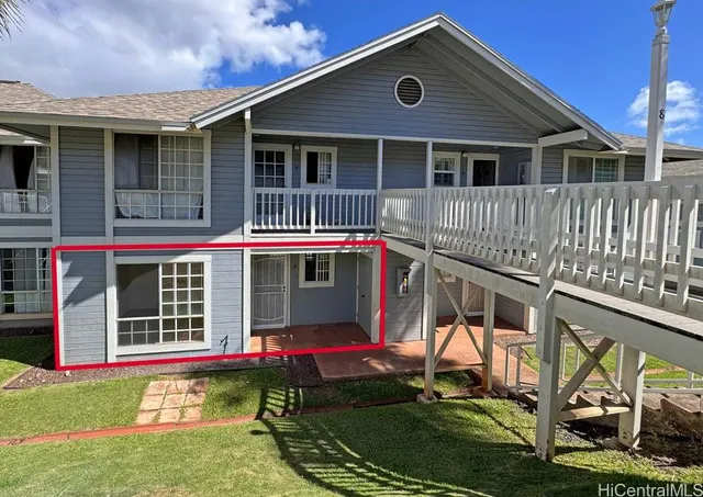 a view of a house with a yard and furniture