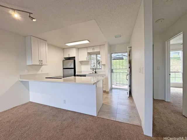 a large white kitchen with a sink