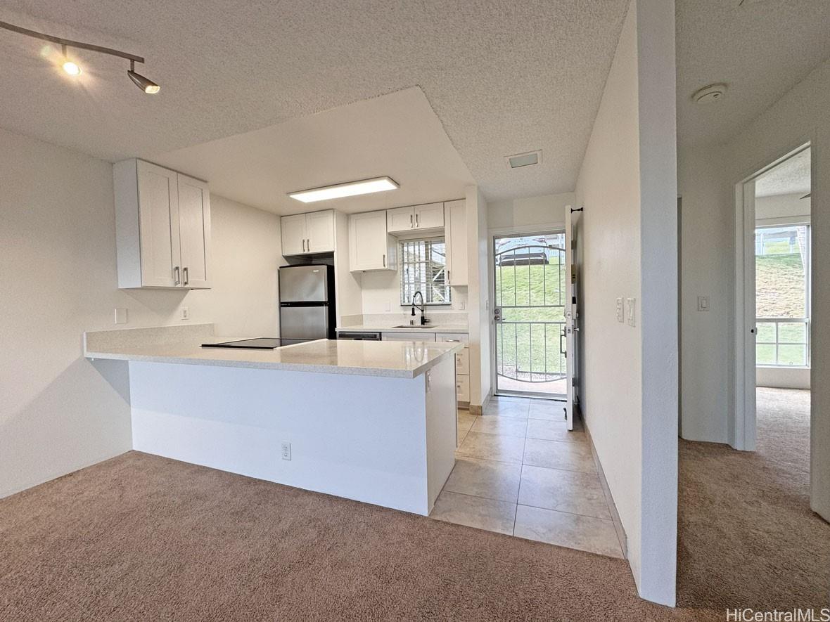92-1150 Hame Street, Unit 8102 Kapolei, HI 96707 - Photo 3 of 19 a large white kitchen with a sink