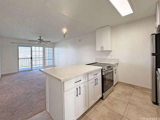 a kitchen with a stove a sink and a refrigerator
