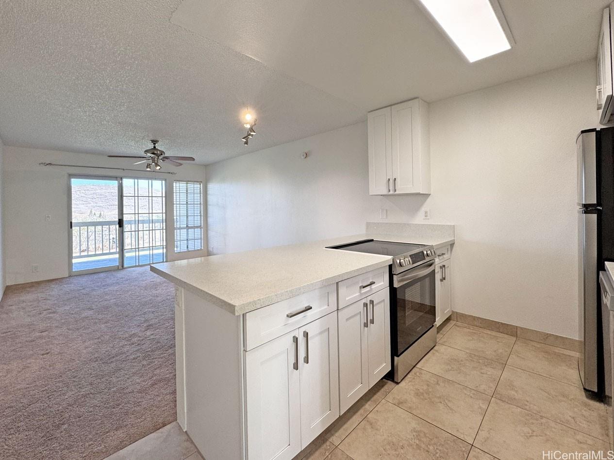92-1150 Hame Street, Unit 8102 Kapolei, HI 96707 - Photo 8 of 19 a kitchen with a stove a sink and a refrigerator