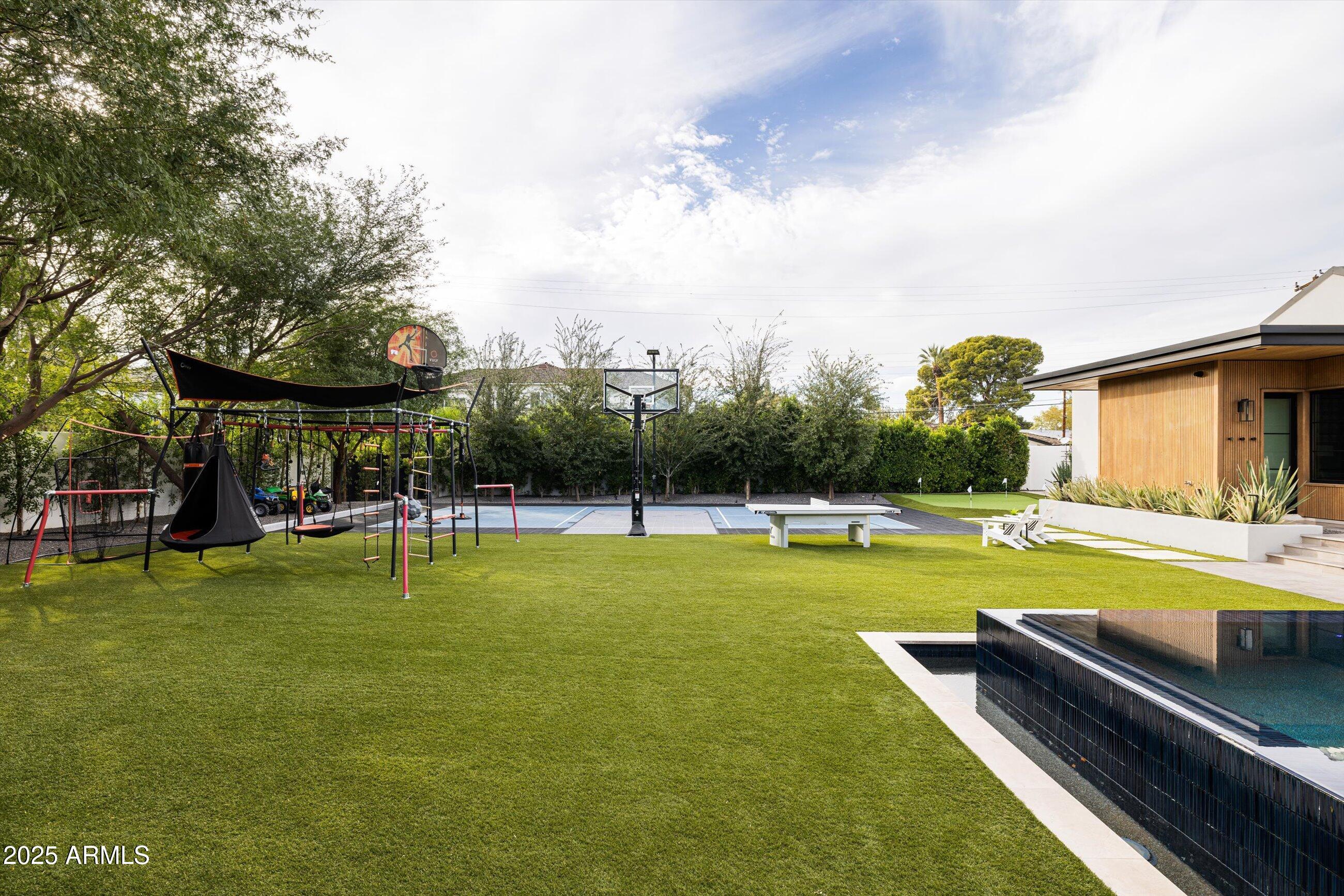 5715 East Monterosa Street Phoenix, AZ 85018 - Photo 102 of 113 a view of a swimming pool with a table and chairs