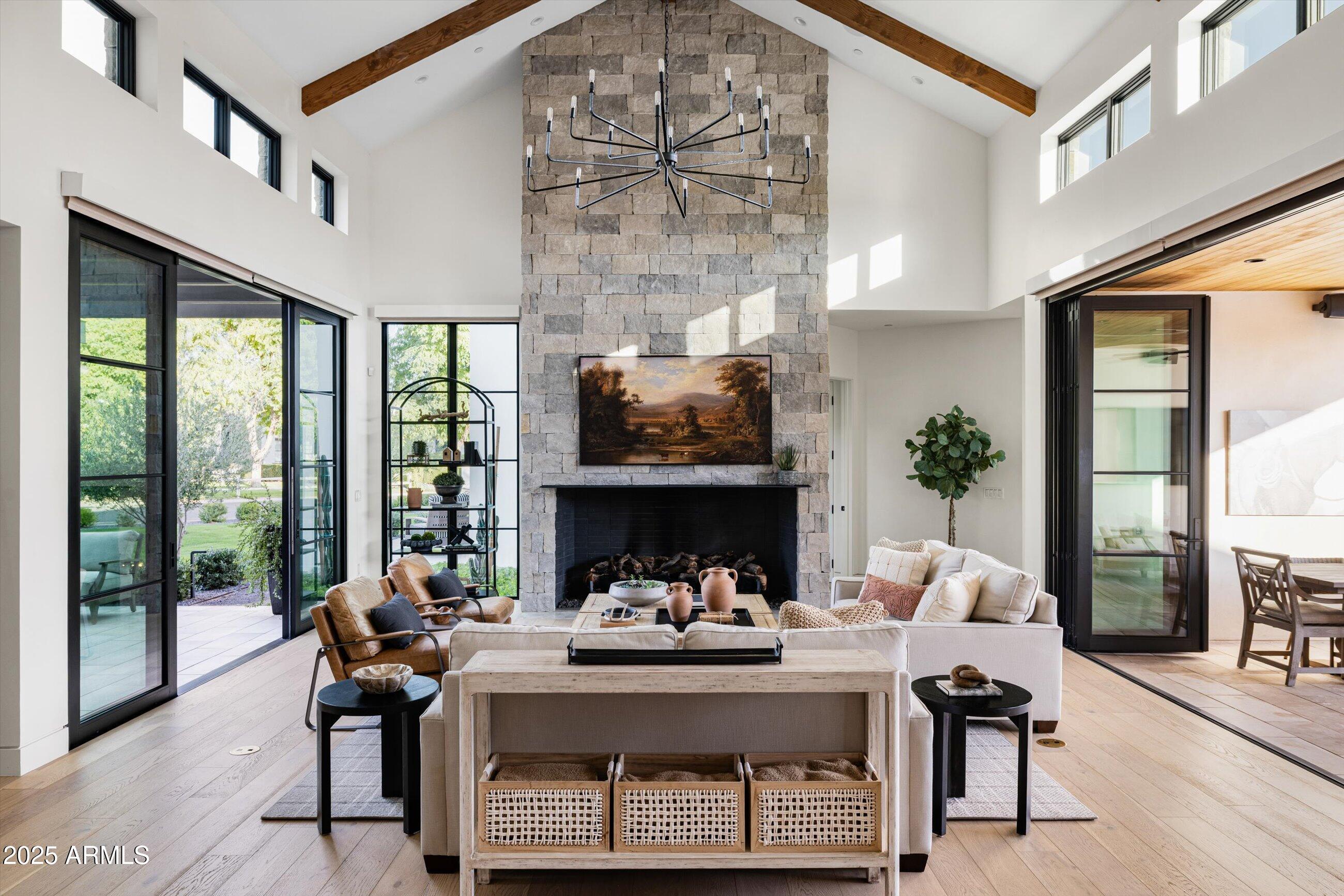 5715 East Monterosa Street Phoenix, AZ 85018 - Photo 12 of 113 a living room with furniture a fireplace and a floor to ceiling window