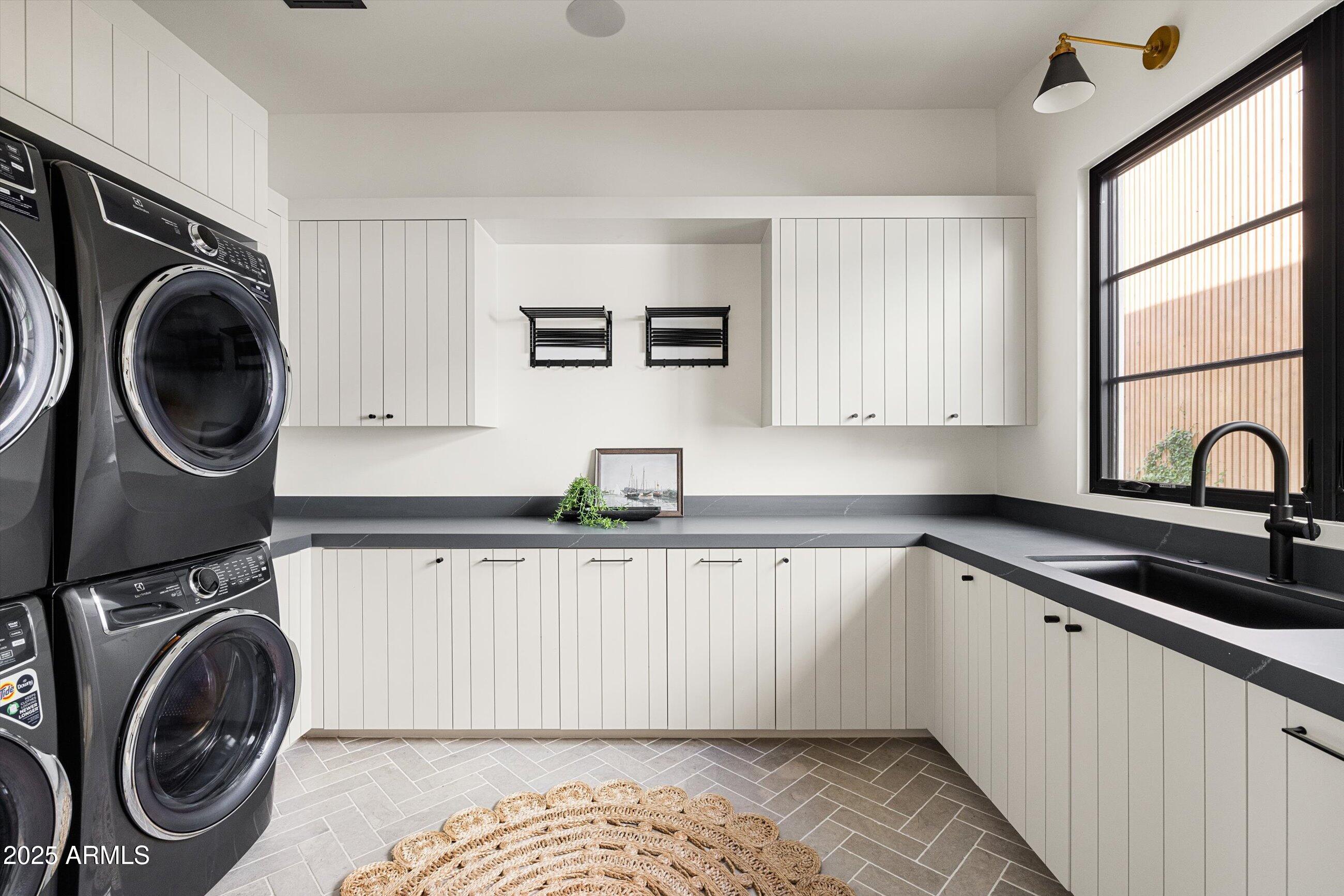 5715 East Monterosa Street Phoenix, AZ 85018 - Photo 36 of 113 a kitchen with a sink a washer and dryer next to a window