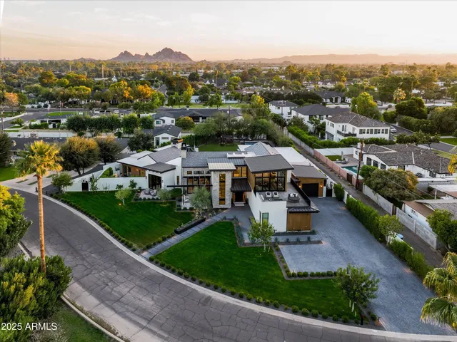 a living room with furniture a fireplace and a floor to ceiling window