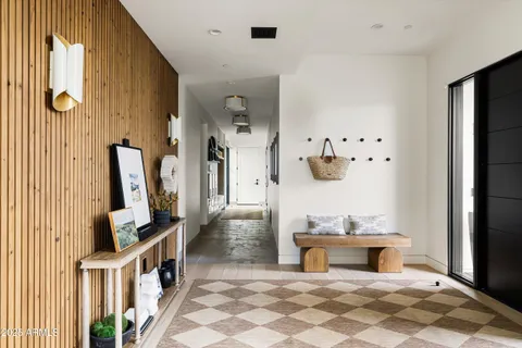 a living room with fireplace furniture and a large window