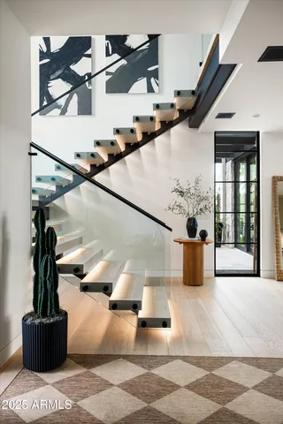 a living room with furniture and a floor to ceiling window