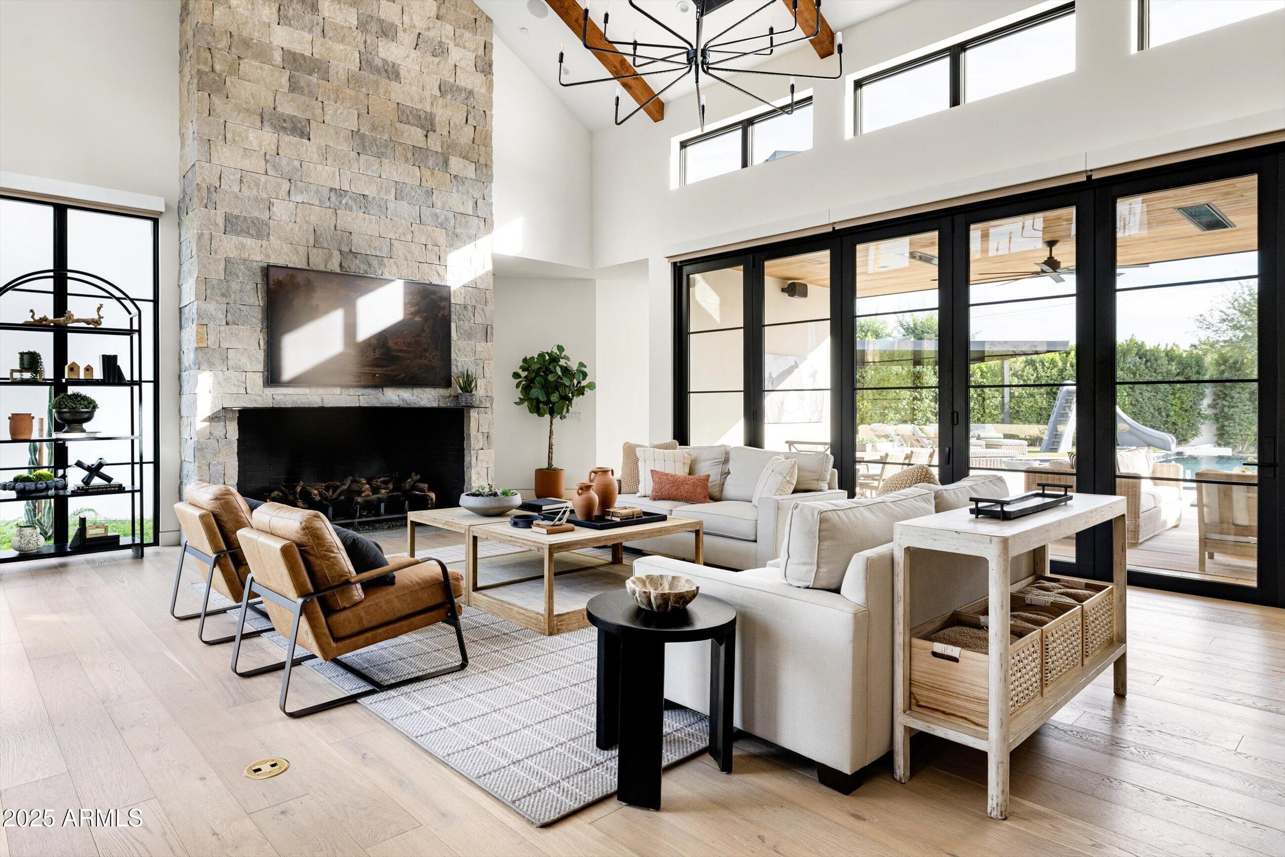 5715 East Monterosa Street Phoenix, AZ 85018 - Photo 72 of 113 a living room with furniture a fireplace and a floor to ceiling window