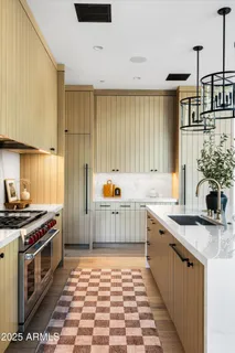 a bedroom with a bed a fireplace and a large window