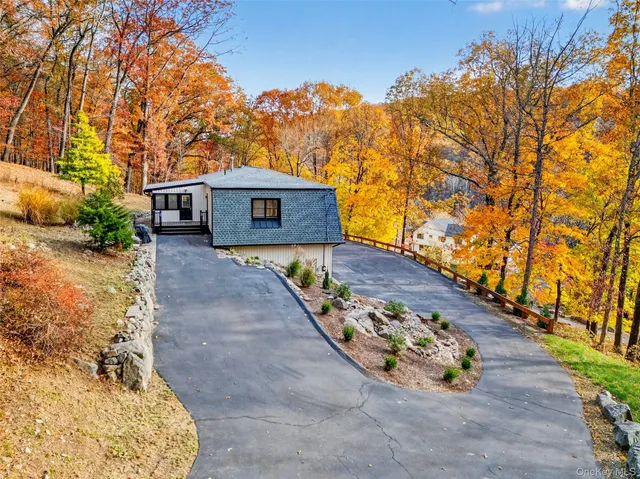 a view of a wooden house with a yard