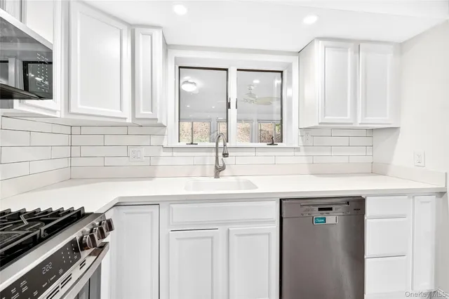 a kitchen with granite countertop a sink and a stove