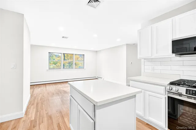 a kitchen with a stove a sink and a microwave